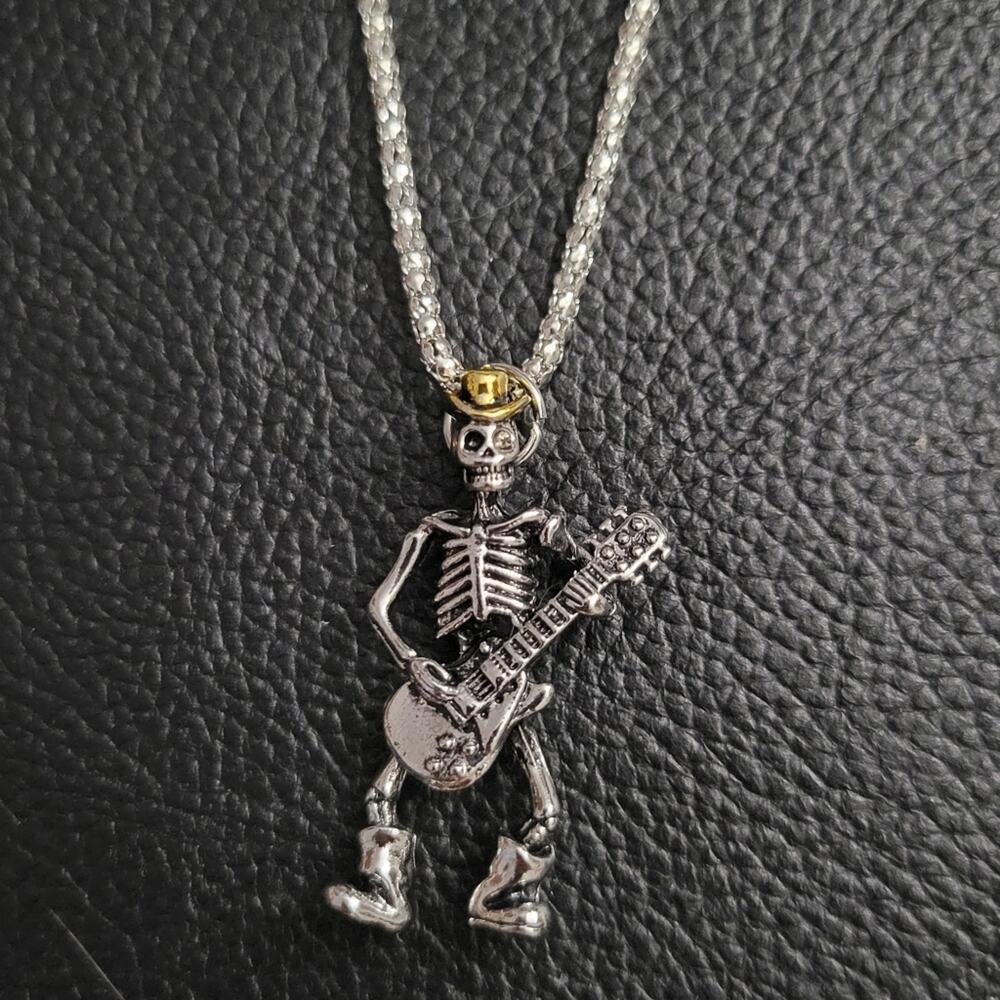 Skeleton playing guitar necklace wearing hat and boots